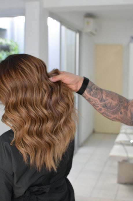 a woman is getting her hair done in a salon