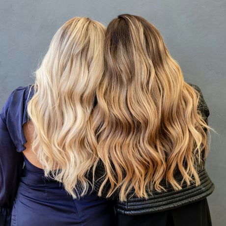 Two women with long, wavy blonde and brunette hair.